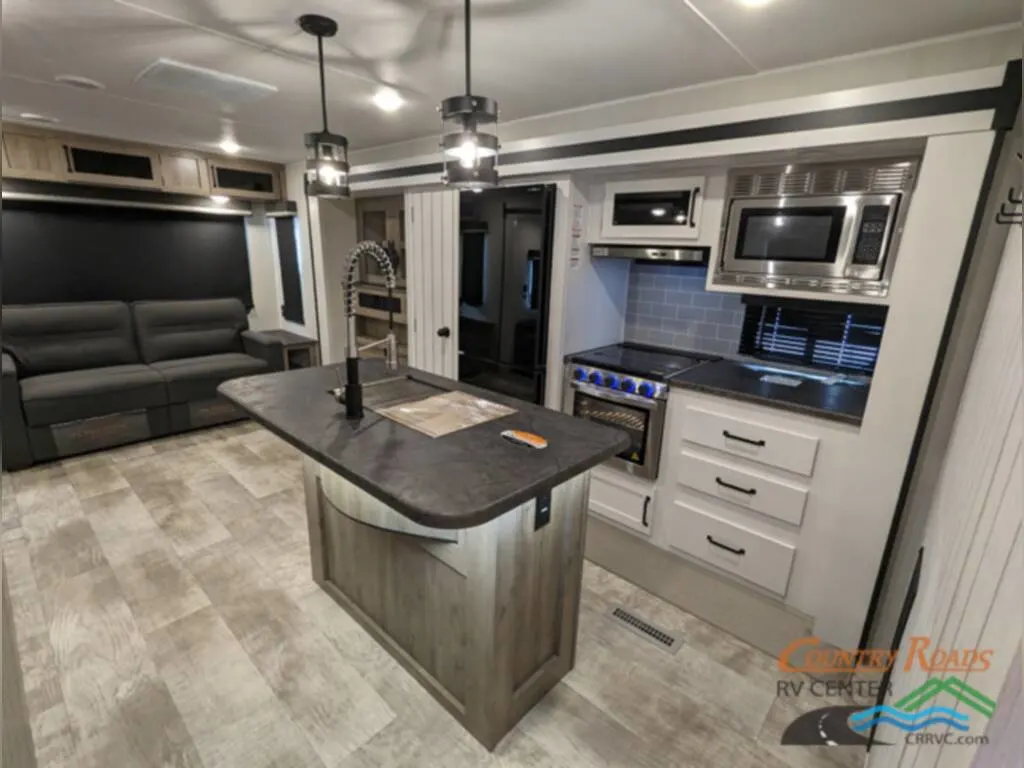 Kitchen with a gas burner, ovens, and drawers.