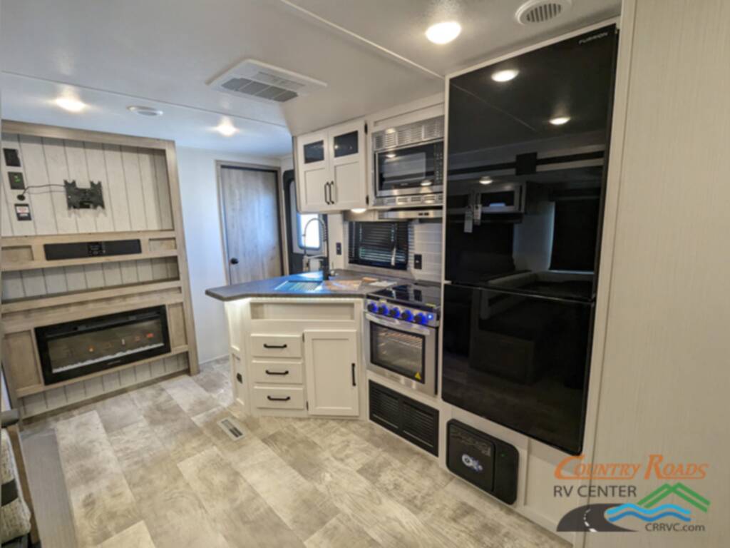 Kitchen with a sink, gas burner, fridge and cabinets.