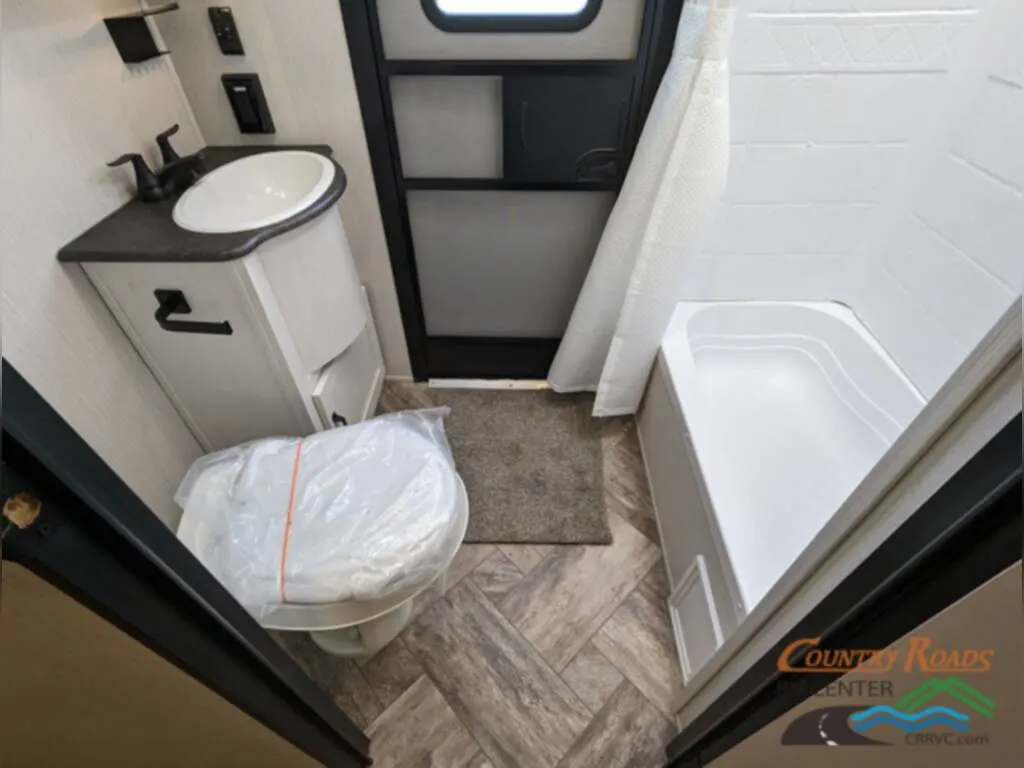 Bathroom with a toilet, sink and a shower.