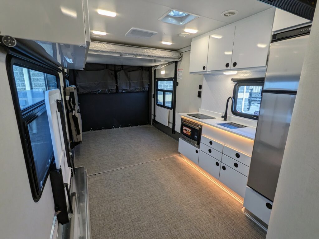 Interior of the New 2024 ATC PLĀ 700 (2816) Aluminum Travel Trailer Toy Hauler RV.