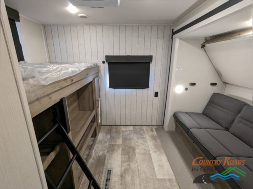 Living area with a sofa and foldable bunk beds.