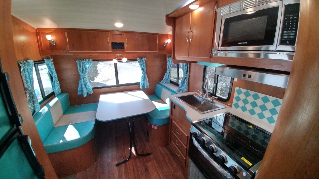 Dinette with a glass windows and overhead cabinets.