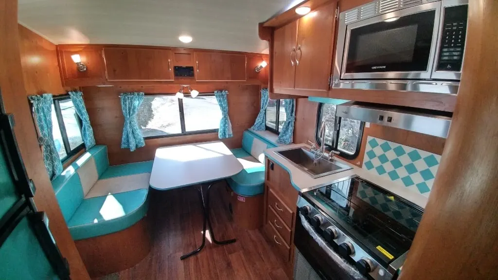 Dinette with a glass windows and overhead cabinets.