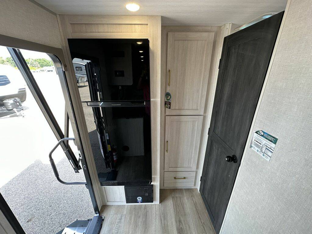 Front entry of the RV with a fridge.