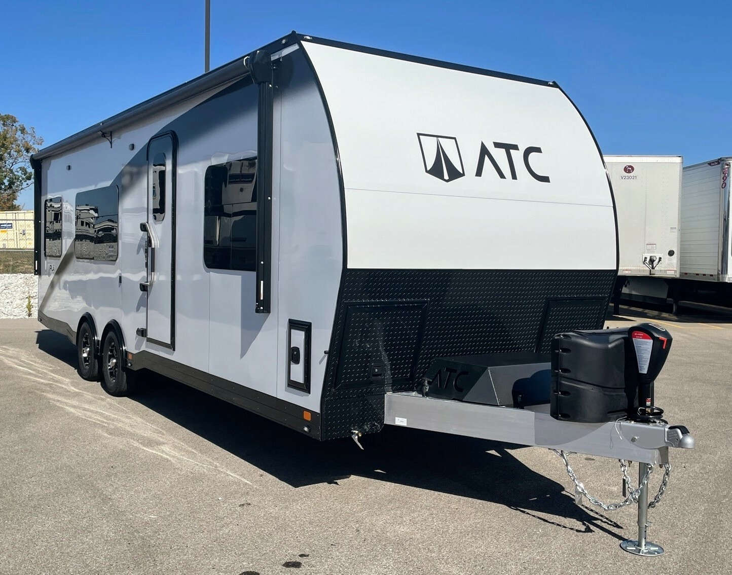 Front view of the New 2024 ATC PLĀ 700 (2816) Aluminum Travel Trailer Toy Hauler RV.