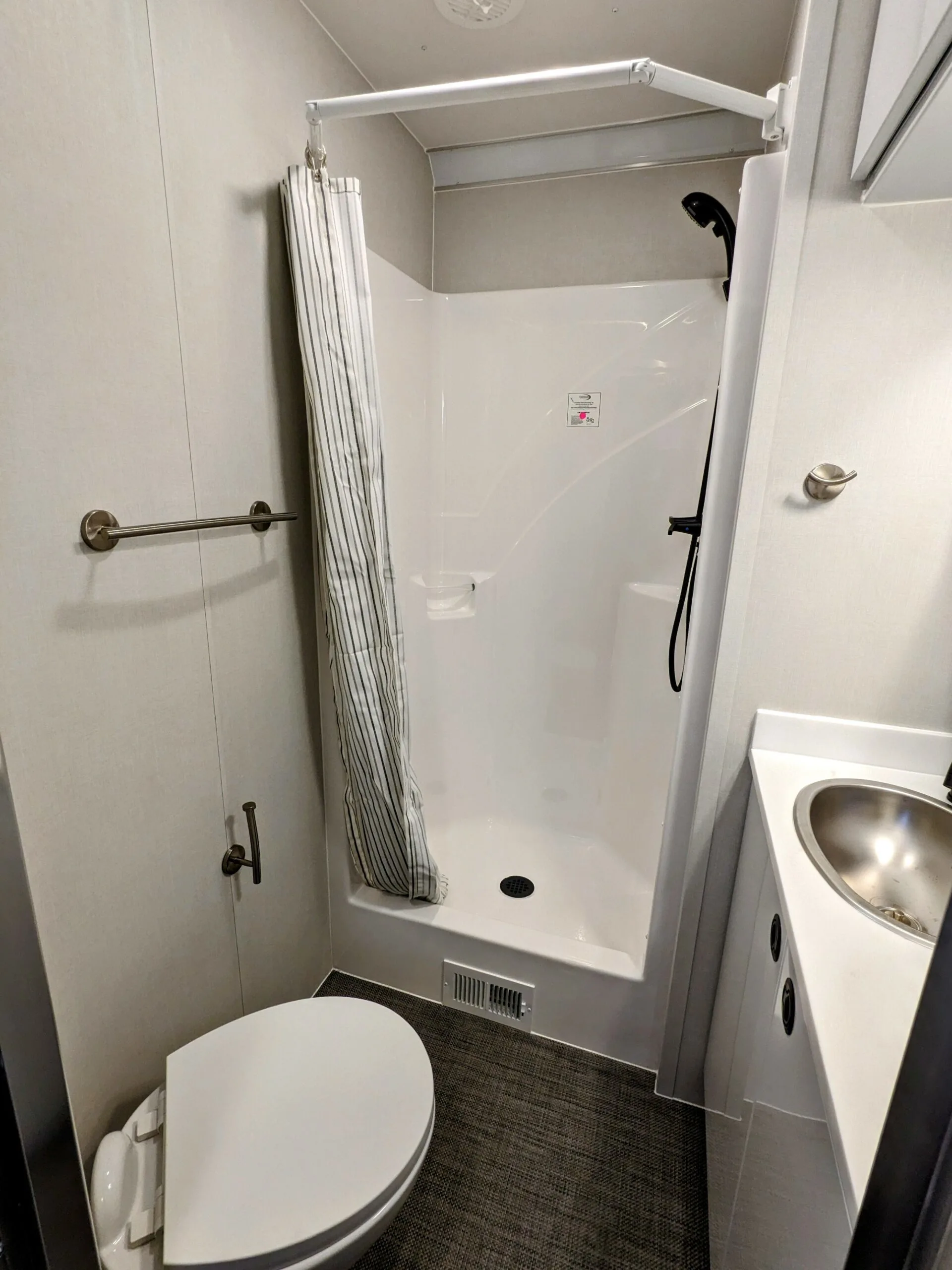 Bathroom with a sink, toilet and a shower.