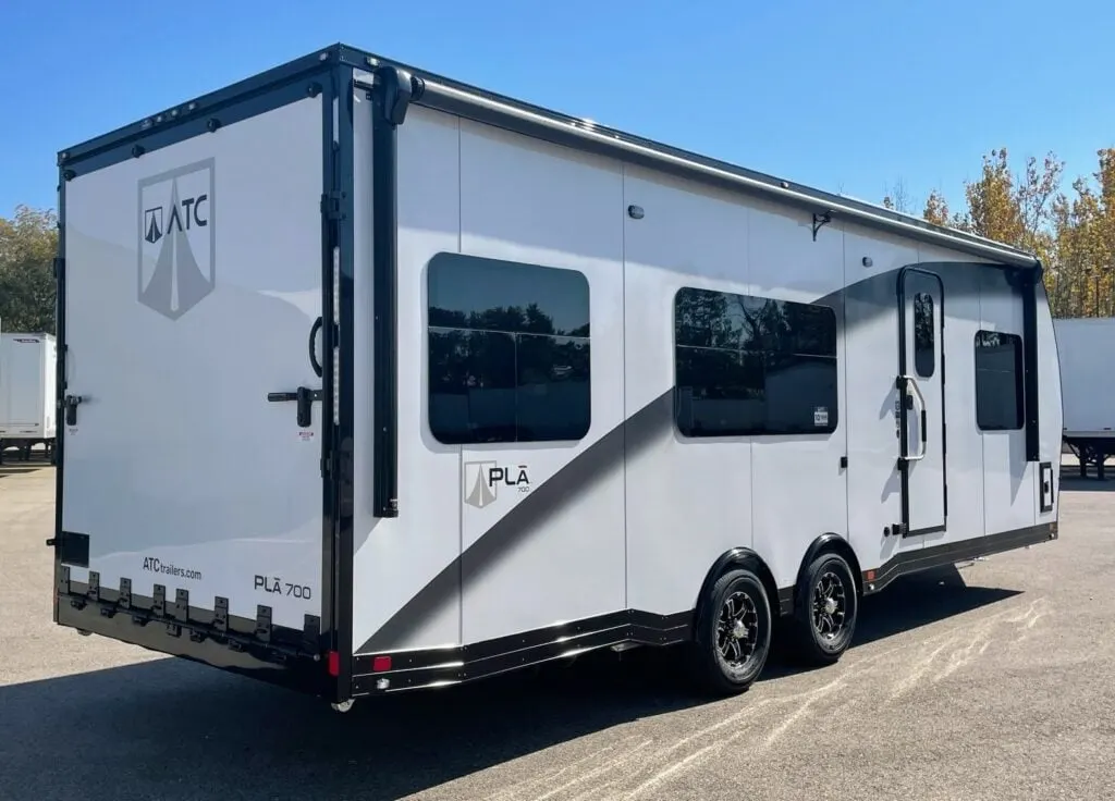 Side view of the New 2024 ATC PLĀ 700 (2816) Aluminum Travel Trailer Toy Hauler RV.