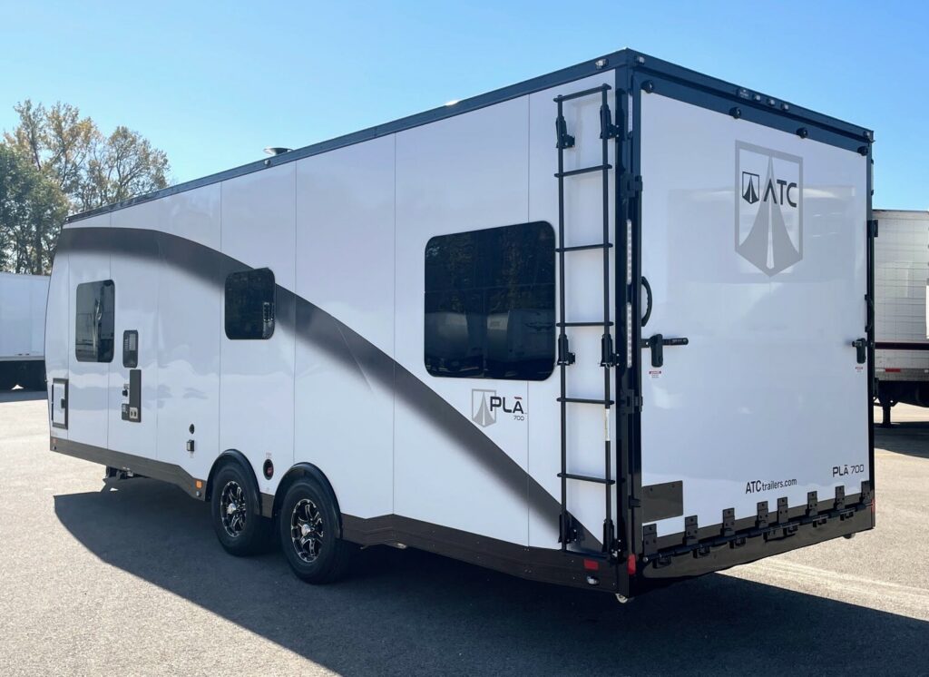 Side view of the New 2024 ATC PLĀ 700 (2816) Aluminum Travel Trailer Toy Hauler RV.