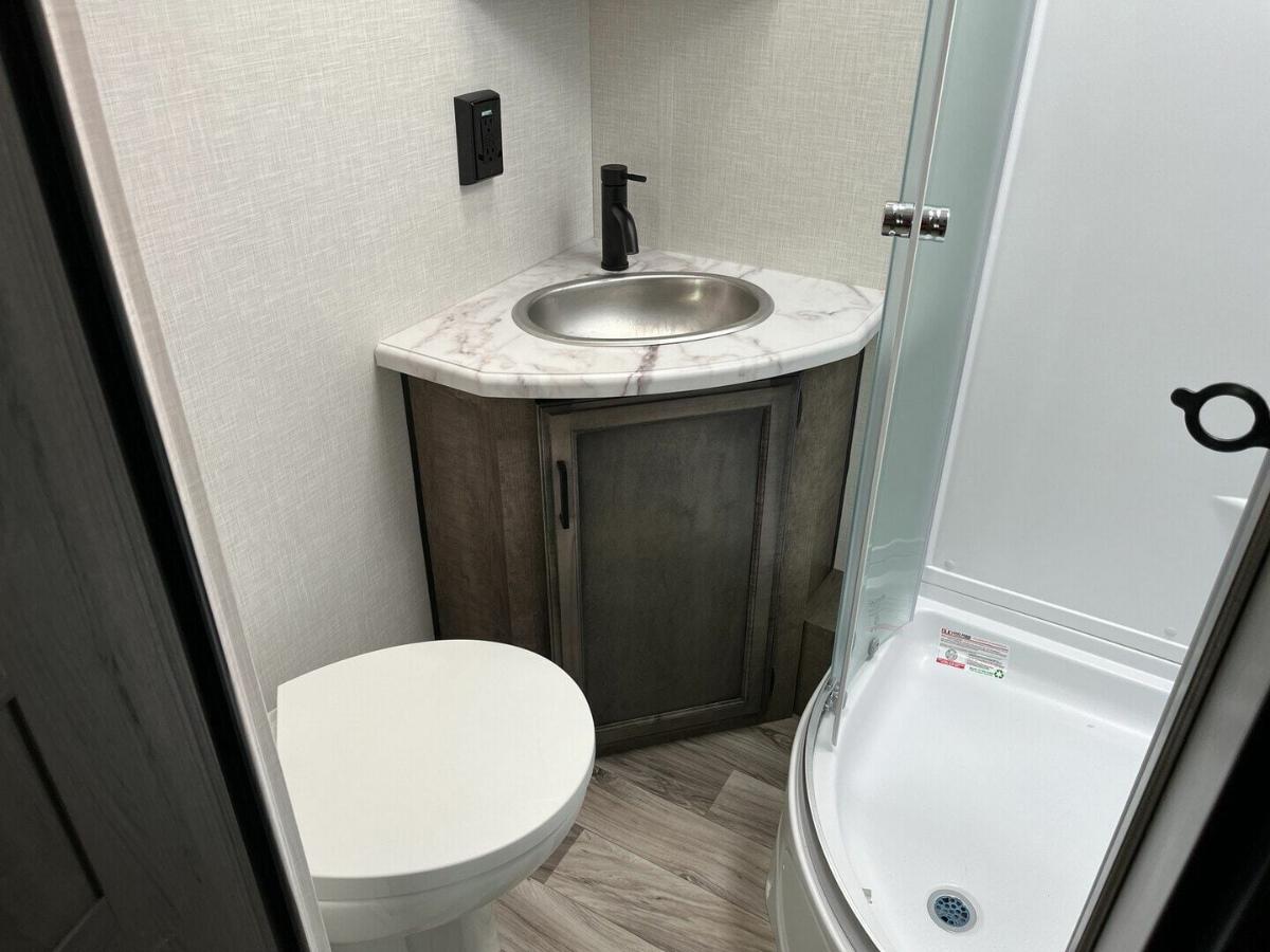 Bathroom with a sink, toilet and a walk-in shower.