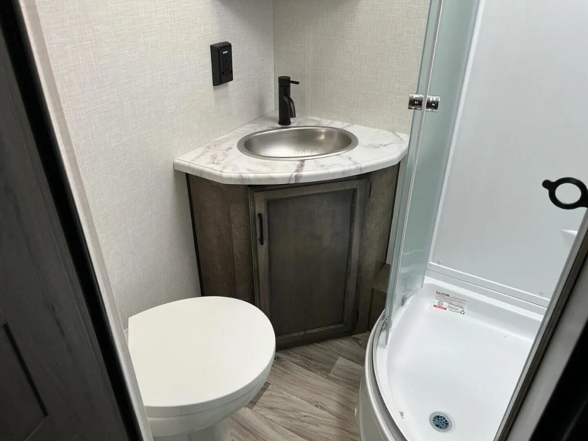 Bathroom with a sink, toilet and a walk-in shower.