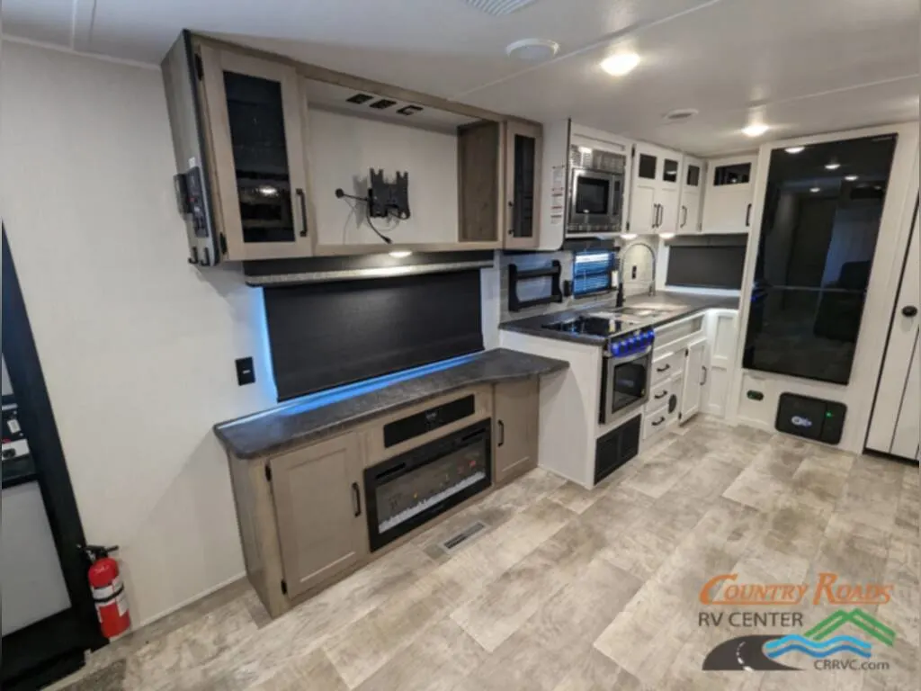 Kitchen with a gas burner, fridge, oven, sink and cabinets.