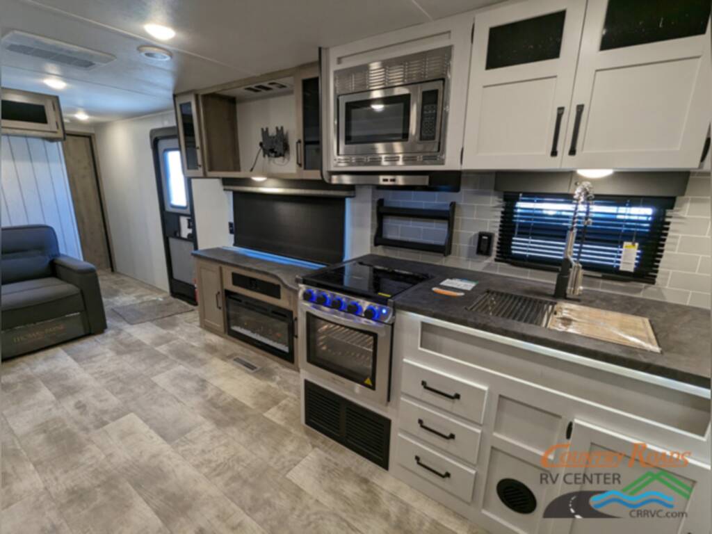 Kitchen with a gas burner, fridge, oven, sink and cabinets.