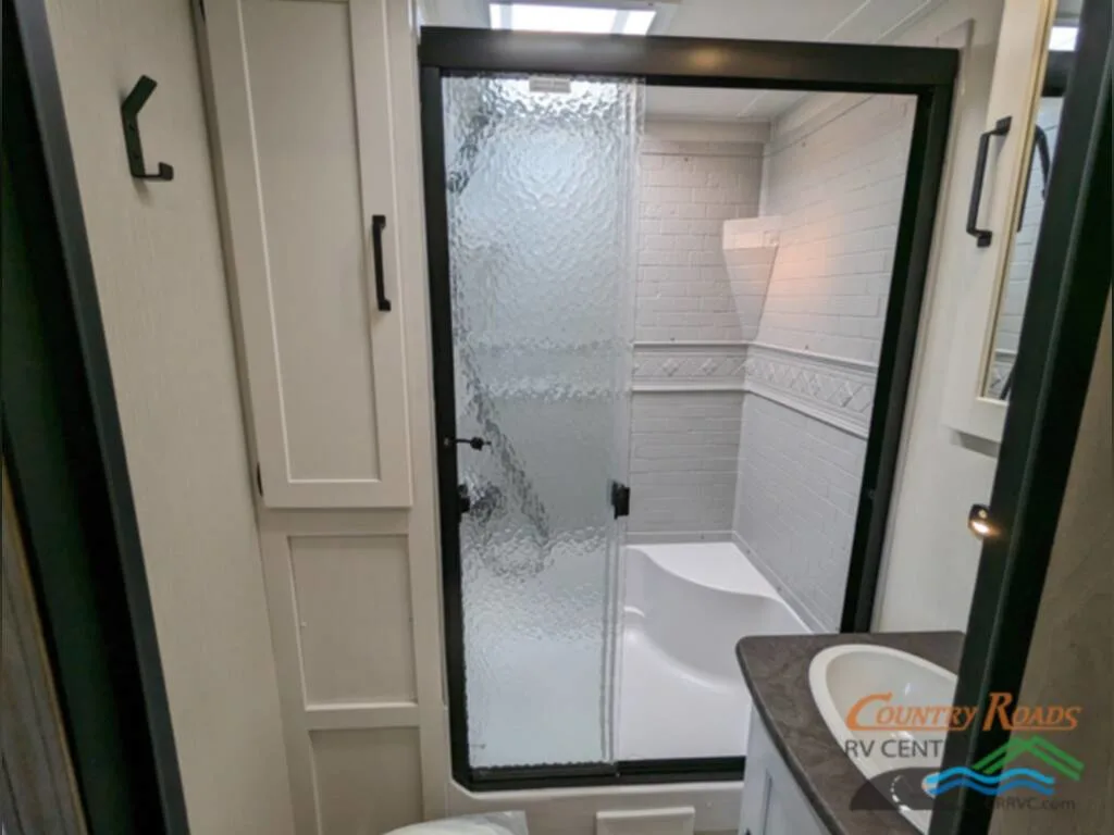 Bathroom with a sink and a walk-in shower.