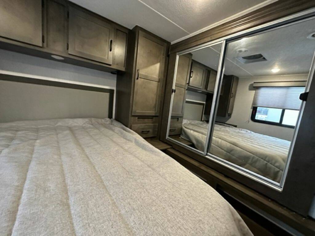 Bedroom with overhead cabinets.