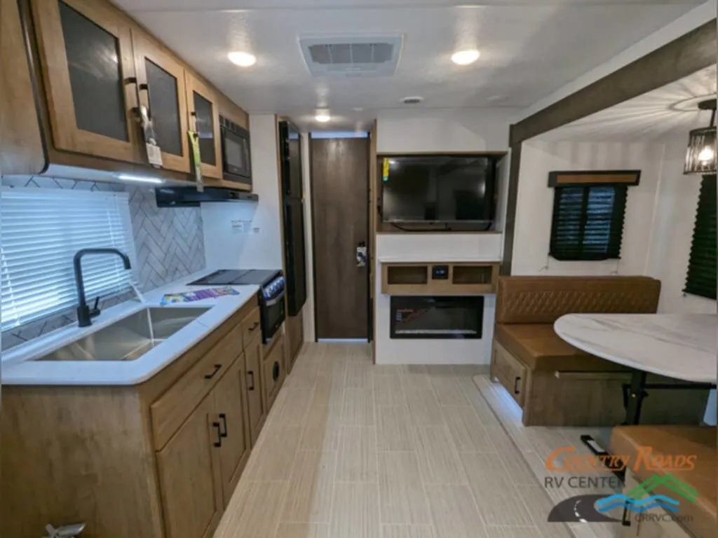 Interior view of the RV with a dinette and a kitchen.