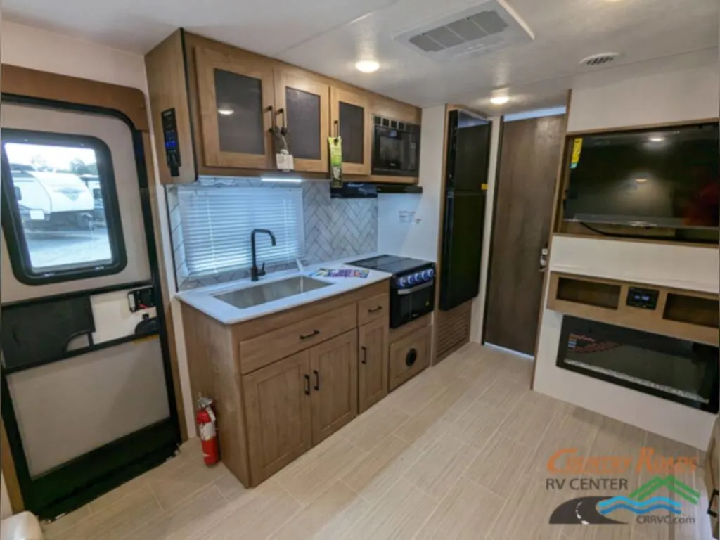 Kitchen with a gas burner, fridge, oven, sink and cabinets.