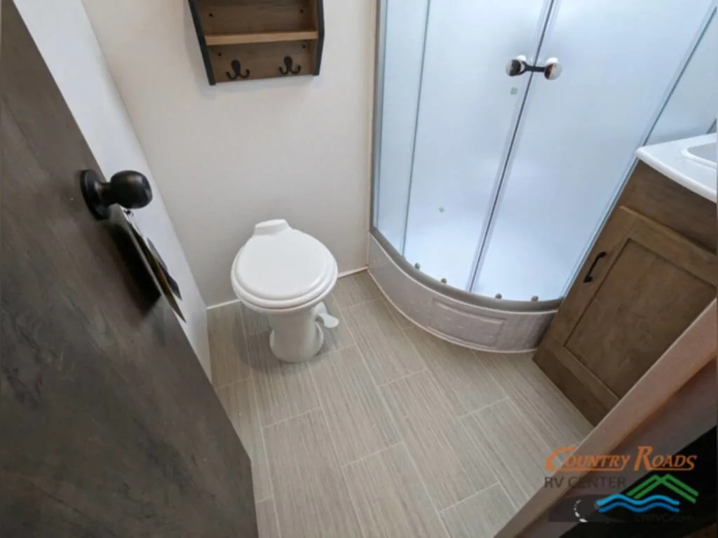 Bathroom with a sink, toilet and a walk-in shower.