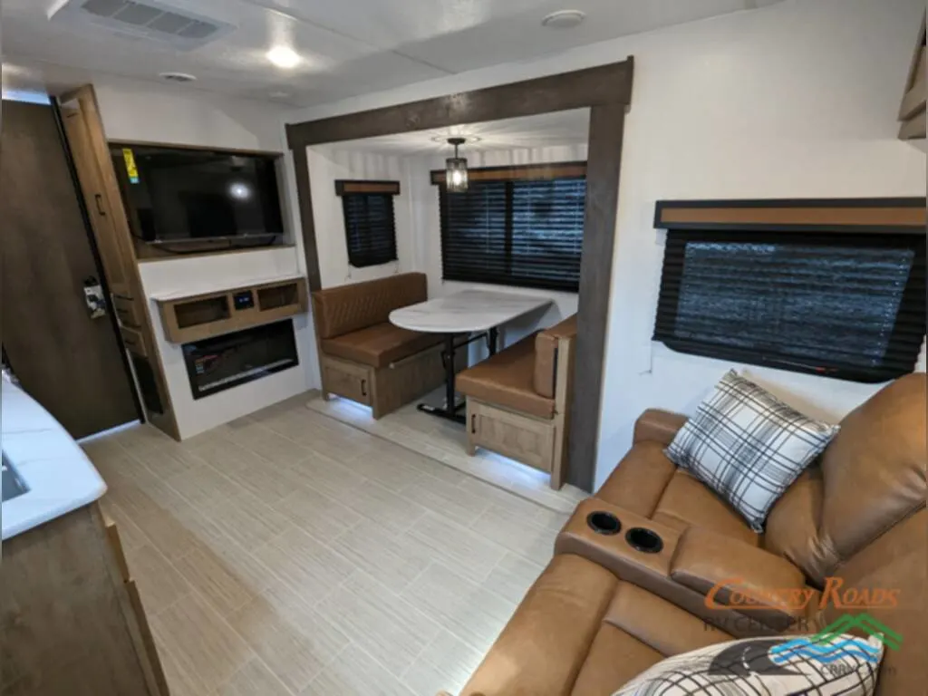 Interior view of the RV with dinette and living area.