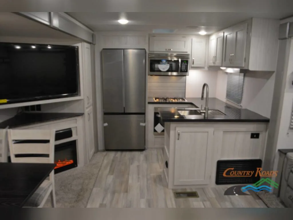 Kitchen with a gas burner, fridge, oven, sink and cabinets.