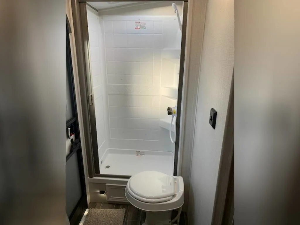 Bathroom with a toilet and a walk-in shower.