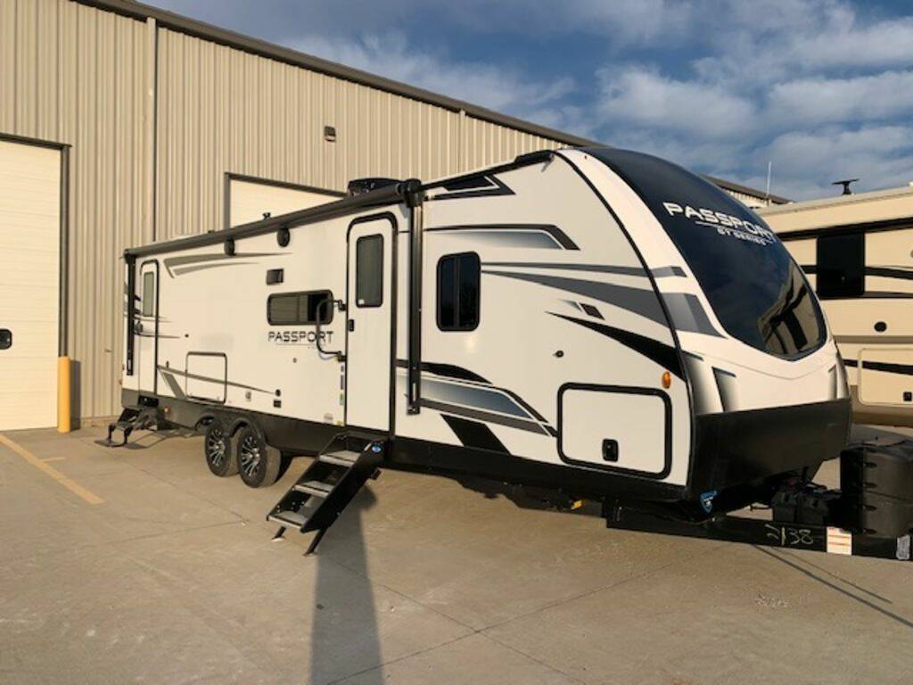 Side view of the New 2023 Keystone Rv Passport GT 2951BH Travel Trailer RV.