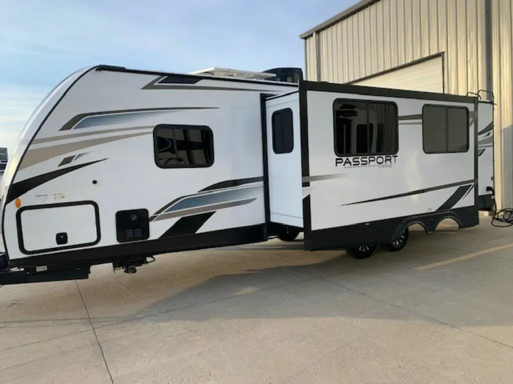 Side view of the New 2023 Keystone Rv Passport GT 2951BH Travel Trailer RV.