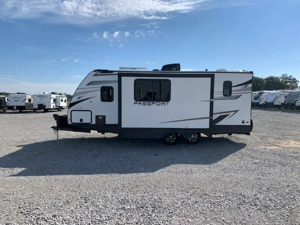 Side view of the New 2023 Keystone Rv Passport SL 221BH Travel Trailer RV.