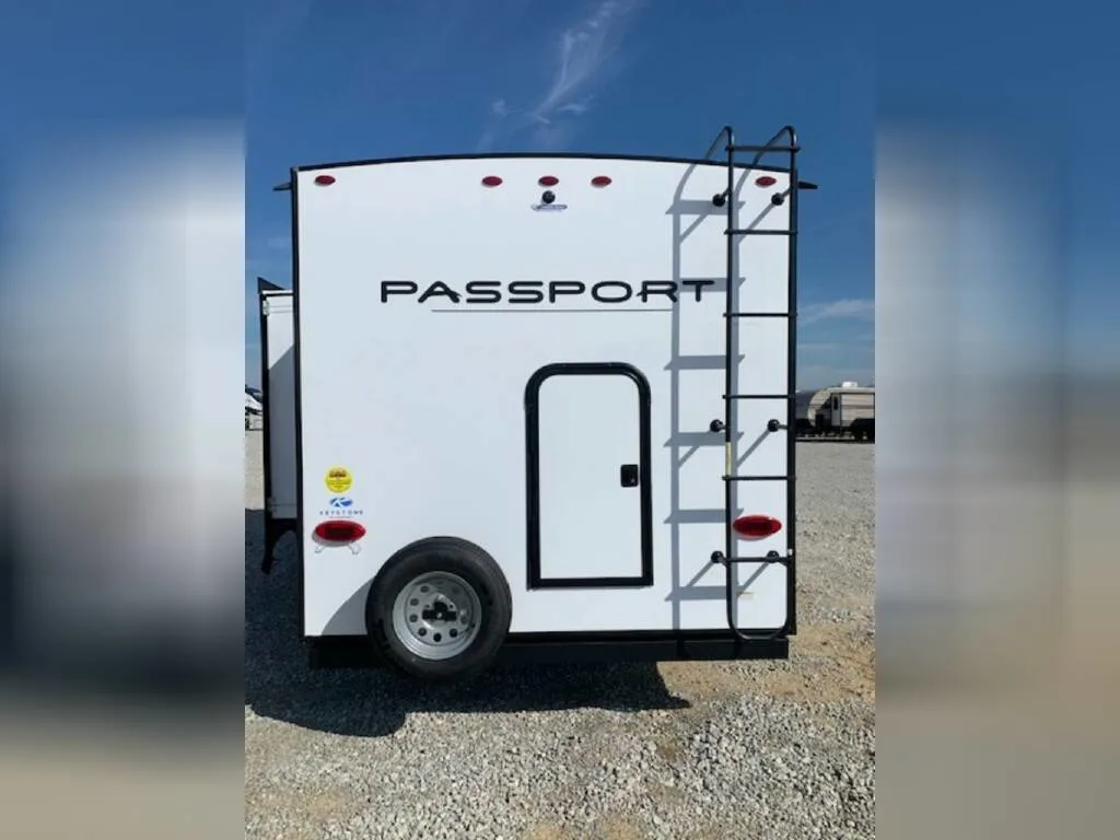 Rear view of the New 2023 Keystone Rv Passport SL 221BH Travel Trailer RV.