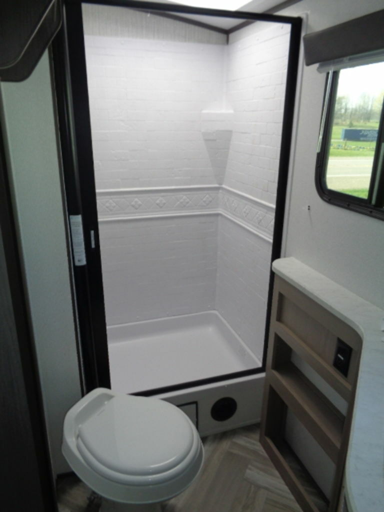 Bathroom with a toilet and a walk-in shower.