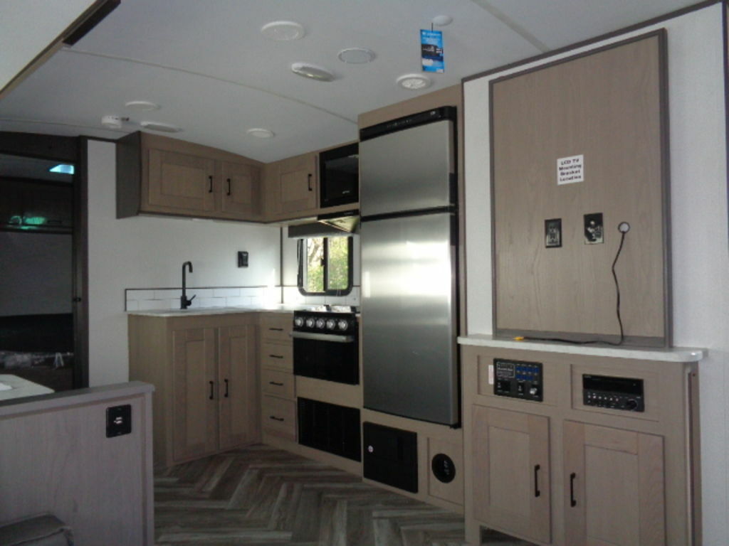 Kitchen with a gas burner, fridge, oven, sink and cabinets.