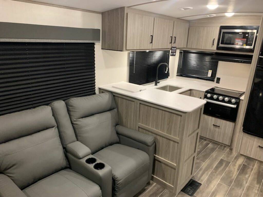 Interior view of the RV with a living space and a kitchen.