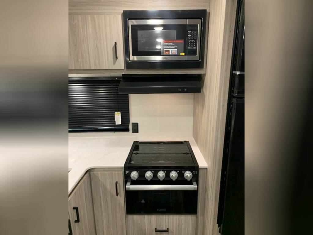 Kitchen with a gas burner, oven and cabinets.