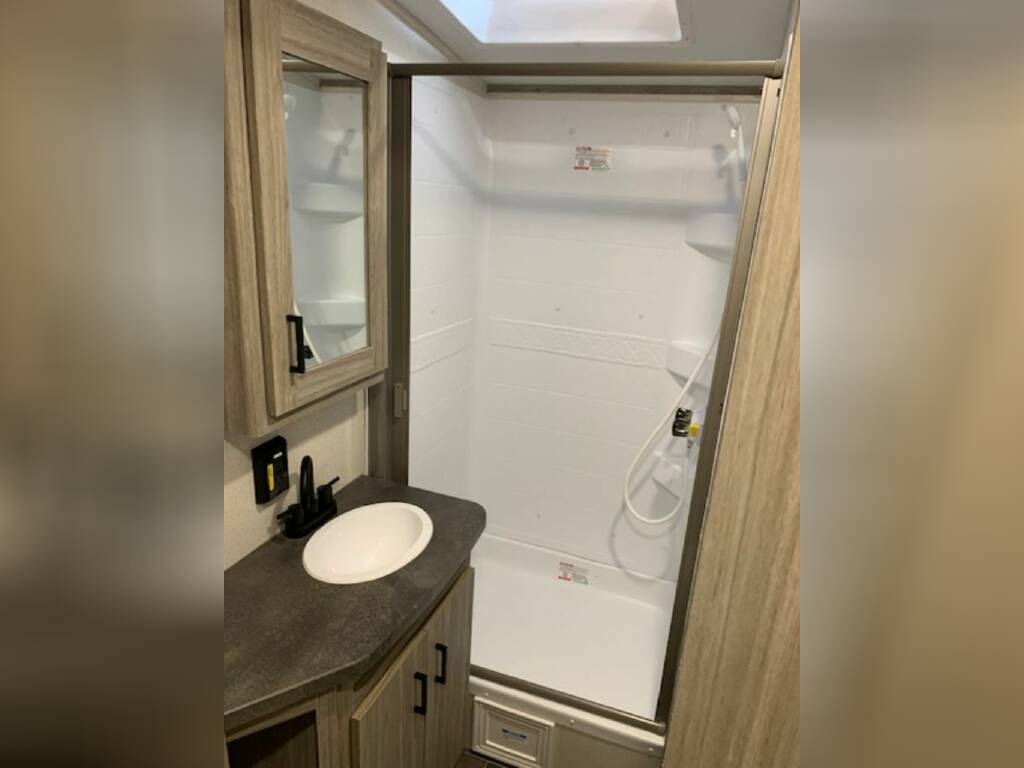 Bathroom with a sink and a walk-in shower.