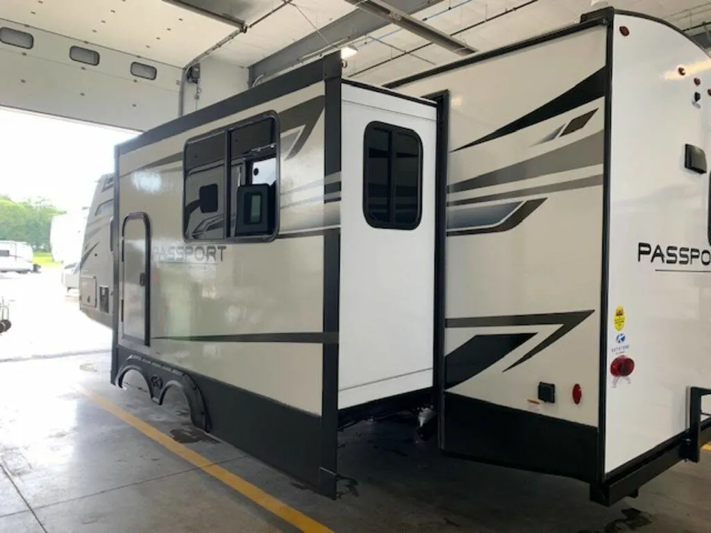 Side view of the New 2023 Keystone Rv Passport GT 2704RK Travel Trailer RV.