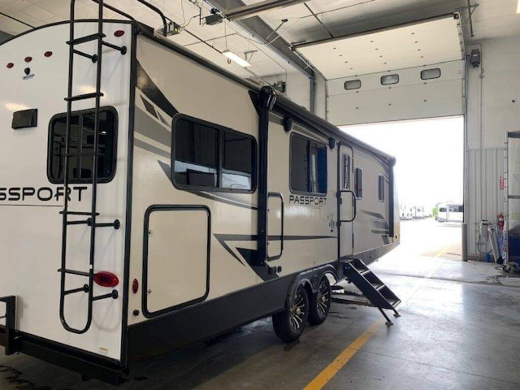 Side view of the New 2023 Keystone Rv Passport GT 2704RK Travel Trailer RV.