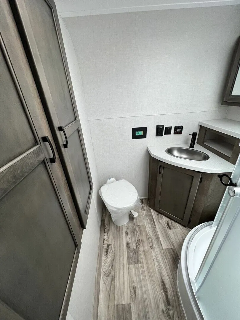 Bathroom with a sink, toilet and a walk-in shower.