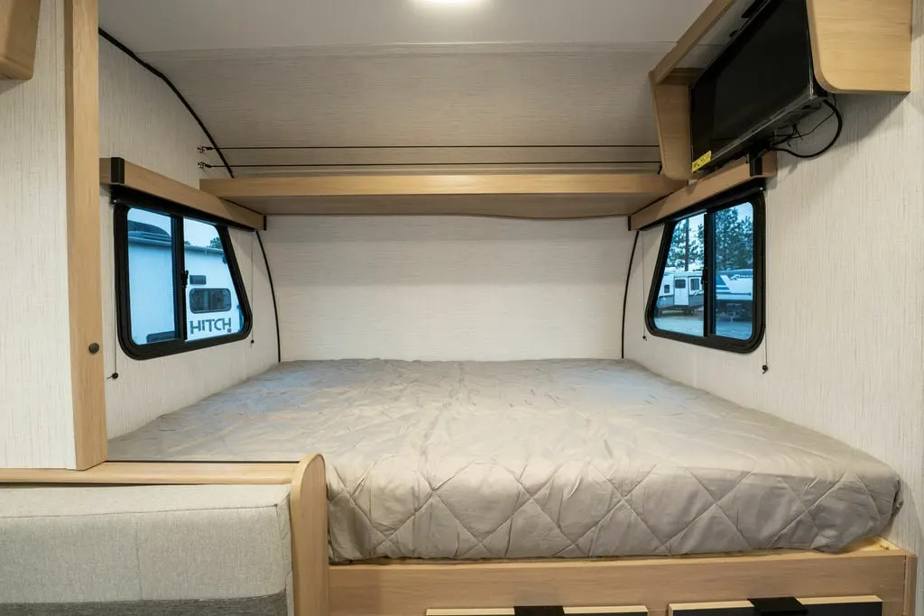 Bedroom with a queen size bed and TV.