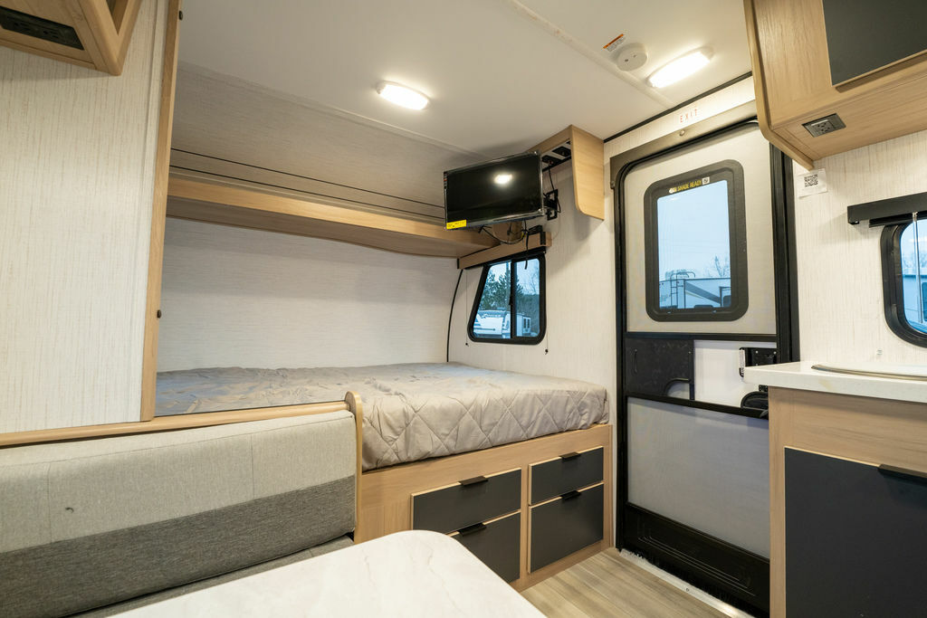 Bedroom with a queen size bed and TV.