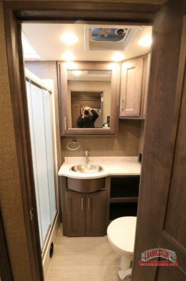 Bathroom with a sink, toilet and a walk-in shower.