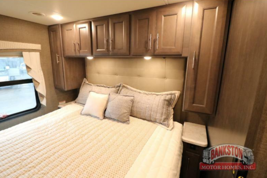 Bedroom with a king size bed, overhead shelf and a shirt closet.