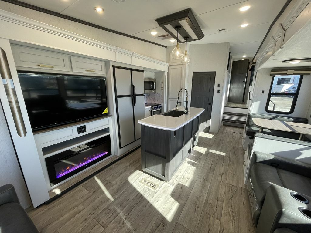 Interior view of the RV with a dinette, living space and a kitchen.