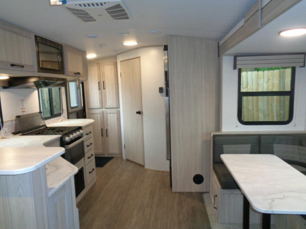 Interior view of the RV with a dinette and a kitchen.