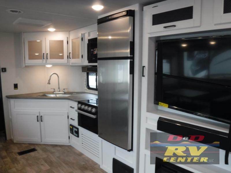 Kitchen with a gas burner, fridge, oven, sink and cabinets.