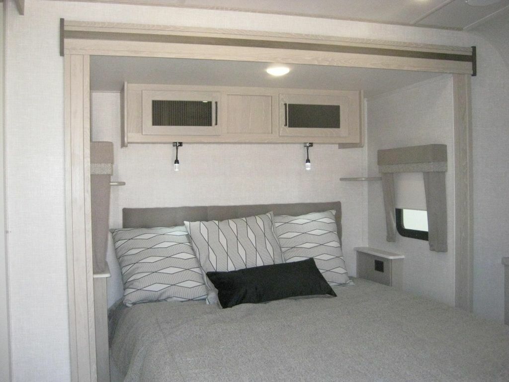 Bedroom with overhead cabinets.