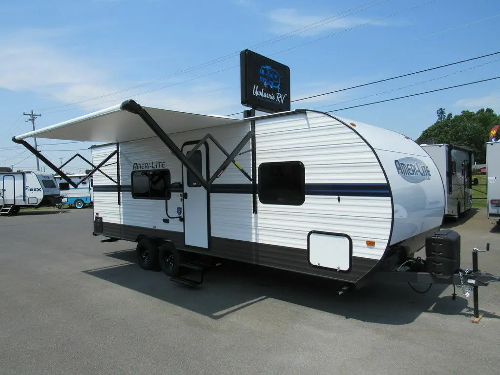 Side view of the RV with an awning.