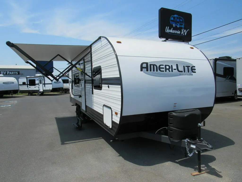 Front view of the RV with an awning.