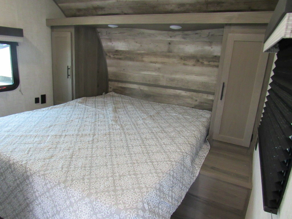 Bedroom with a queen size bed and a shirt closet.