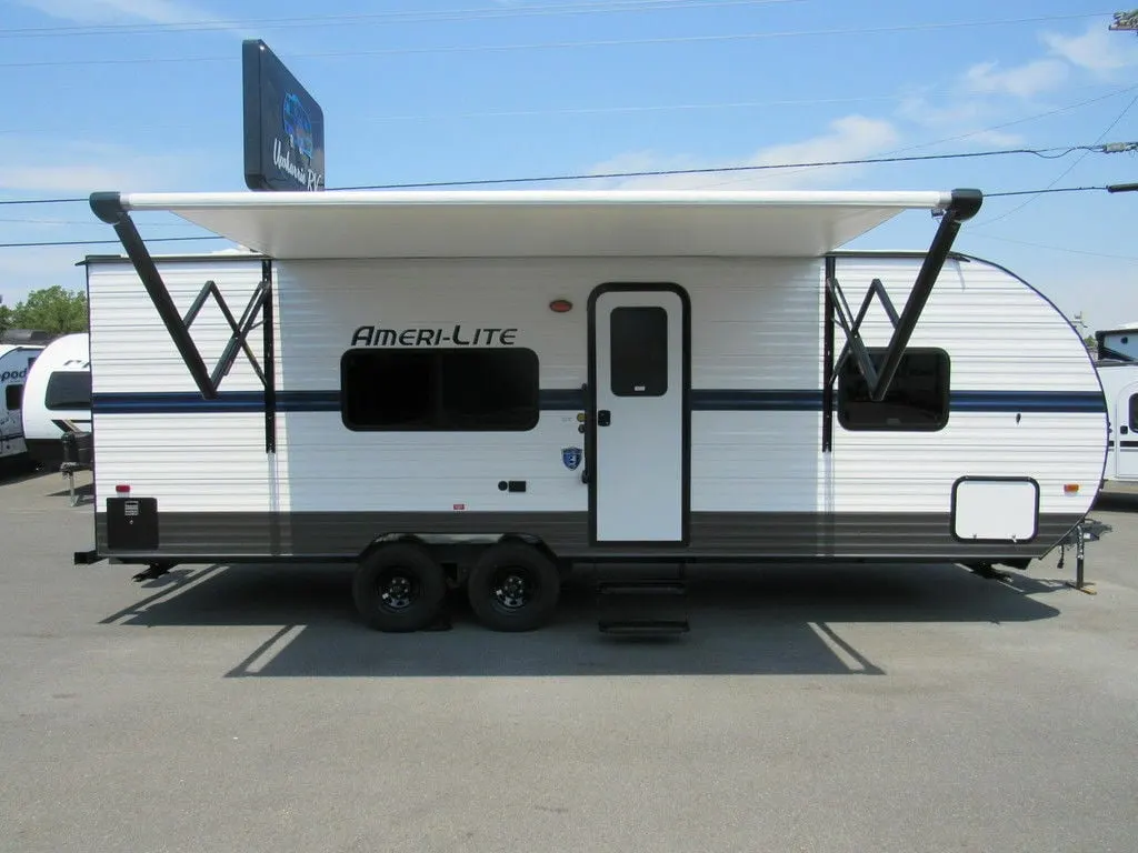 Side view of the RV with an awning.