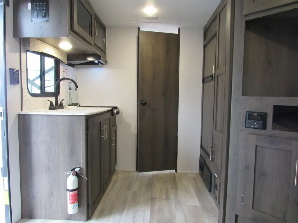 Kitchen with a gas burner, fridge, oven, sink and cabinets.