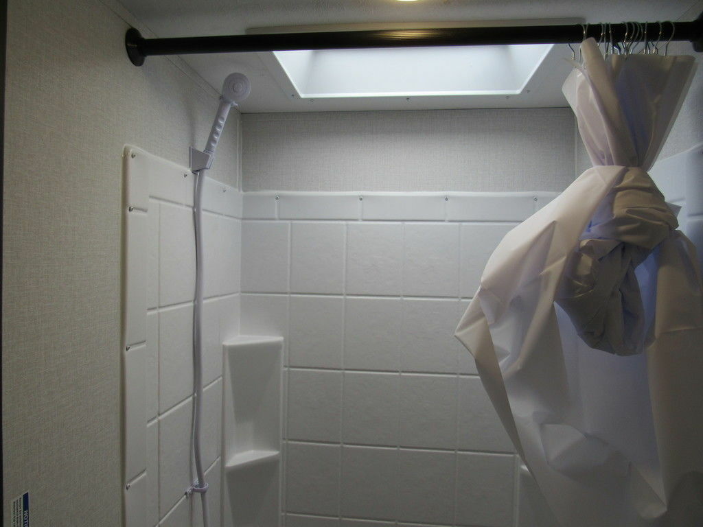 Bathroom with a shower and skylight.